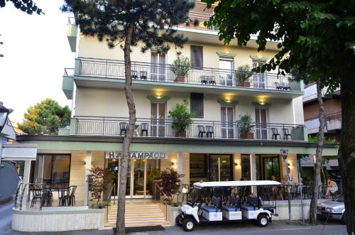 um carrinho de golfe estacionado em frente a um edifício em Hotel Sampaoli em Bellaria-Igea Marina