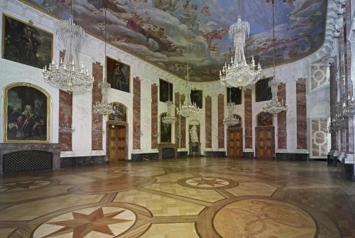 a large room with chandeliers and paintings on the ceilings at Hotel Kurpfalzstuben in Mannheim