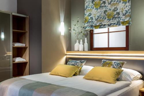 Postel nebo postele na pokoji v ubytování Wine Wellness Hotel Amande Hustopeče