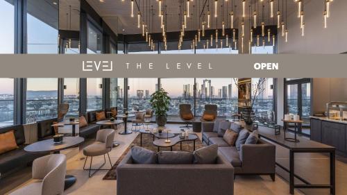 a lobby with furniture and a view of the city at Meliá Frankfurt City in Frankfurt/Main