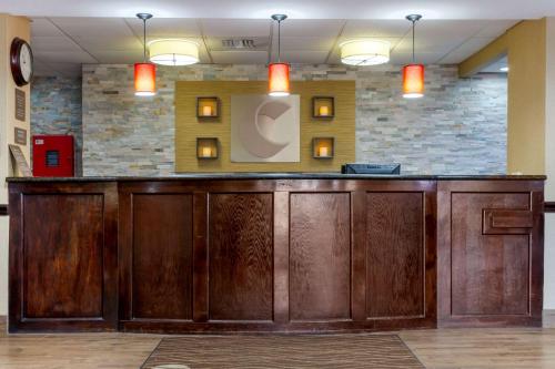 a large wooden bar in a room with lights at Comfort Inn Marion - West Memphis in Marion
