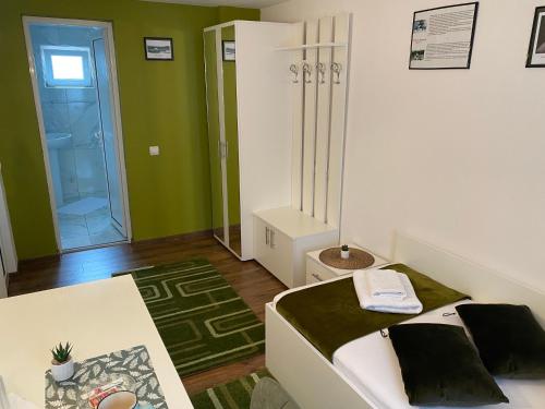 a small room with a bed and a glass door at Pensiunea Pictorilor in Baia Mare