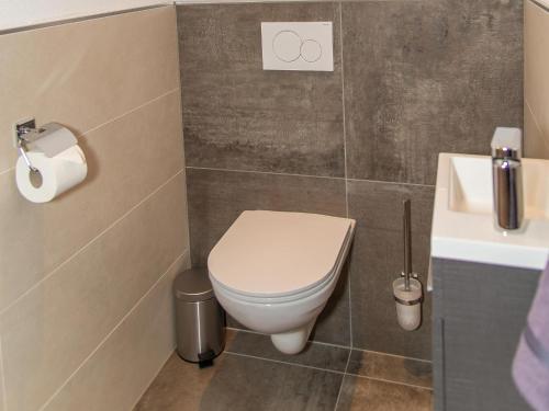 a bathroom with a toilet and a sink at Gasthof Appartements Gamskar in Bad Gastein