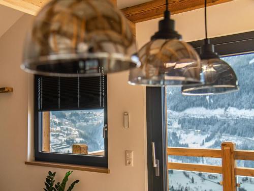a chandelier hanging in a room with a window at Gasthof Appartements Gamskar in Bad Gastein
