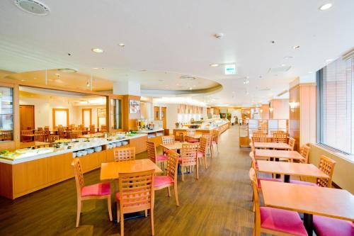 a restaurant with wooden tables and chairs and a cafeteria at Sapporo Tokyu REI Hotel in Sapporo