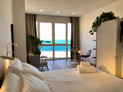 a bedroom with a bed with a view of the ocean at La Vacanza Ortigia in Siracusa