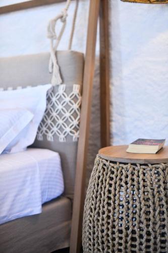 a book on a table next to a bunk bed at Toxotis Villas in Armenistis
