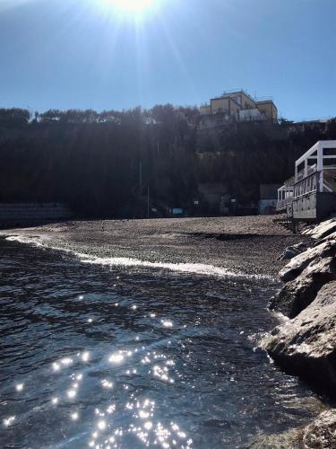 a river with the sun reflecting on the water at Il Riccio Apartment 28 in Procida