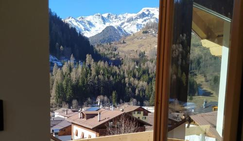 a view of a mountain from a window at Appartamento Mary - Casa Green - Dog friendly, box auto in Cogolo