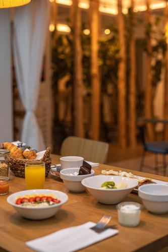 a wooden table with bowls of food on it at Lux Isla in Talamanca