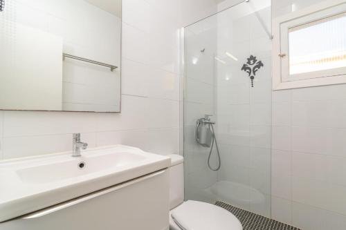 a bathroom with a sink and a toilet and a shower at Casa Blanca -Port d'Alcudia- in Port d'Alcudia