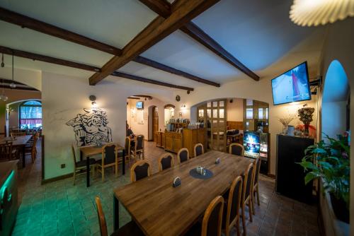 a dining room with a large wooden table and chairs at Radegastova chalupa in Frýdek-Místek