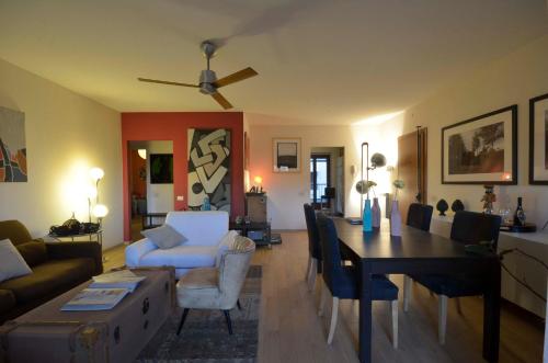 a living room with a couch and a dining room at Assago Centro - Appartamento 100 mq - in Assago