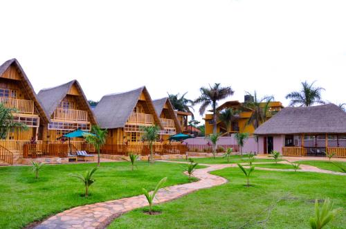 a resort with a path in the middle of a yard at Pelican Lodge & Marina in Entebbe