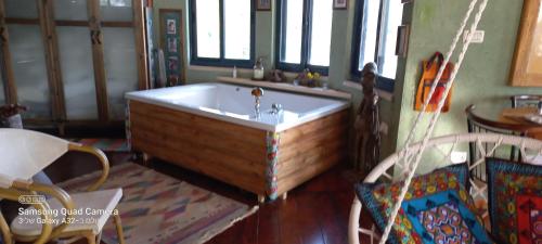 a bath tub with a sink in a room at קטלב kta-love in Kammon