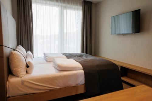 a hotel room with a bed with a window at Avenue Pallova 28 in Plzeň