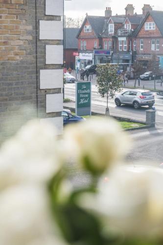 a group of white flowers in front of a building at The Elizabeth House Hotel in Southampton