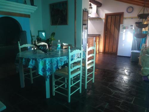 a dining room table with chairs and a blue table cloth at Casa Almenara in Almenara de Tormes