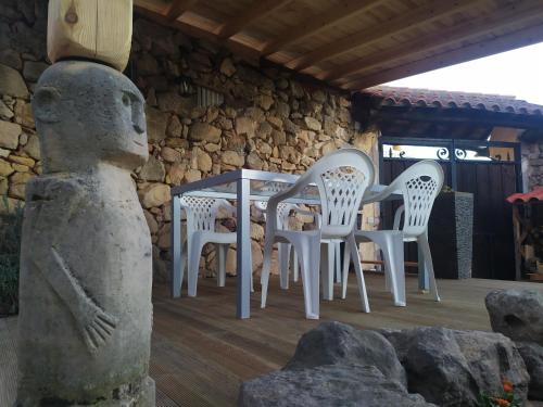 a group of white chairs and a table in a building at Casa Almenara in Almenara de Tormes