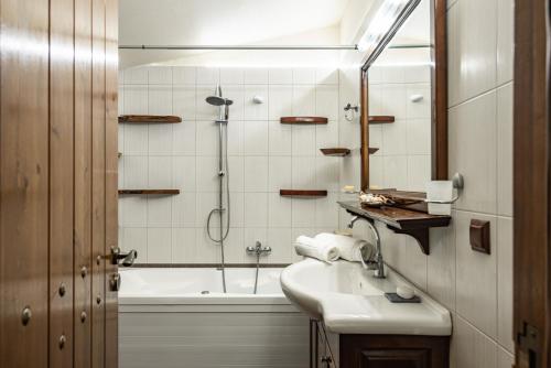 a bathroom with a shower and a sink and a tub at StoneMill Villa, a Sumptuous Escape, By ThinkVilla in Éxo Khóra
