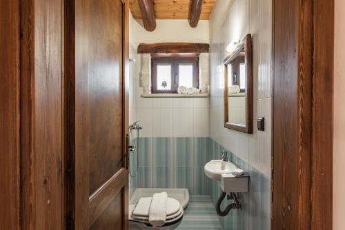 a bathroom with a toilet and a sink at StoneMill Villa, a Sumptuous Escape, By ThinkVilla in Éxo Khóra
