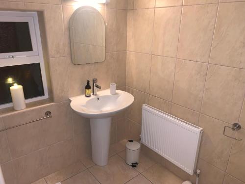 a bathroom with a sink and a mirror and a window at Alta House in Westport