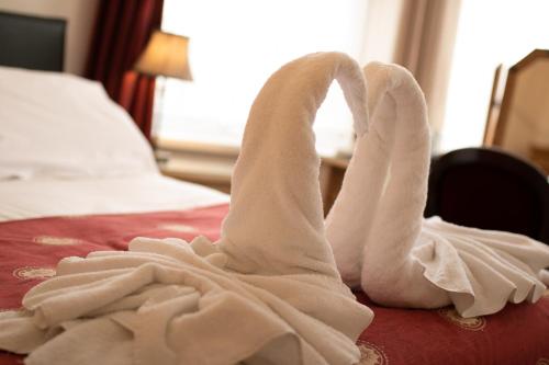 a swan made out of towels on a bed at Skegness The Royal Hotel in Skegness