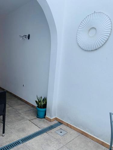a room with a white wall with a fan at B&B NONNA TINA in Gemini