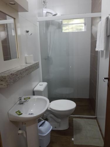 a bathroom with a toilet, sink, and shower at Recanto do Sul in Florianópolis