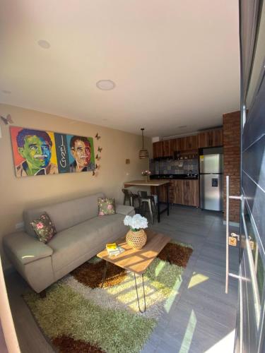 a living room with a couch and a table at Apartaestudios - Casa Tamarindo in Aracataca