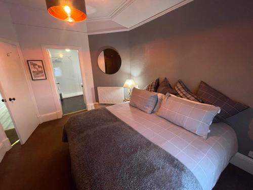 a bedroom with a large bed with pillows on it at The Upper Largo Hotel & Restaurant in Lundin Links