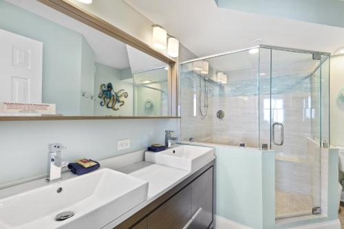 a bathroom with two sinks and a shower at 115 Charleston Oceanfront Villas Beach Daze in Folly Beach