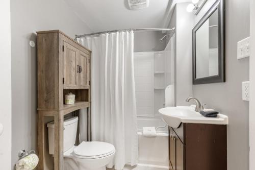 a bathroom with a toilet and a sink at 118 E ARCTIC UNIT B SALTY SHACK ACROSS THE ST FROM BEACH in Folly Beach