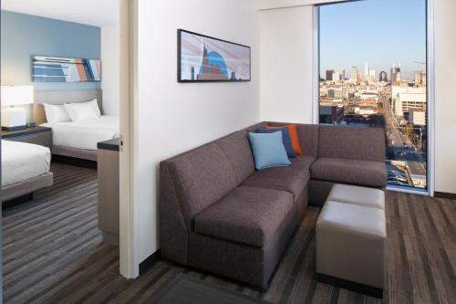 a hotel room with a couch and a bed at Hyatt House Nashville at Vanderbilt in Nashville