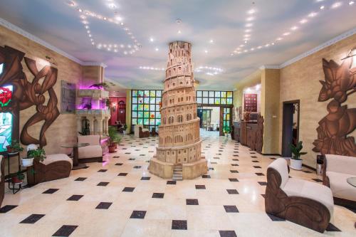 a lobby with a statue in the middle of a building at Art Hotel Babylon in Sunny Beach