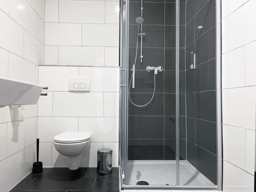 La salle de bains est pourvue d'une douche, de toilettes et d'un lavabo. dans l'établissement Hochwertige Studios für Monteure I home2share, à Stemshorn
