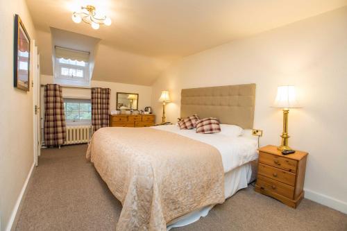 a bedroom with a large white bed and a window at The Upper House in Stoke on Trent
