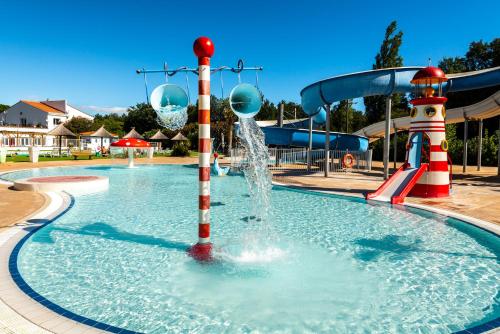 a pool with a water park with a water slide at Camping maeva Club Argelès Vacances in Argelès-sur-Mer