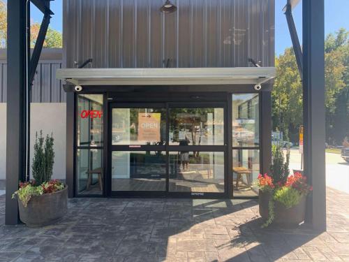 a entrance to a store with two potted plants at Urban Boutique Hotel; BW Signature Collection in Greenville