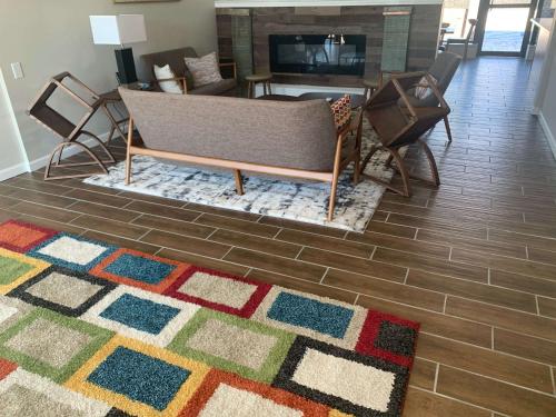 a living room with a couch and a fireplace at Urban Boutique Hotel; BW Signature Collection in Greenville