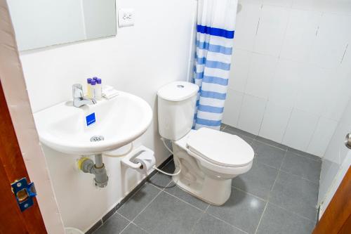 a bathroom with a toilet and a sink at Hotel ITACO in Cartagena de Indias