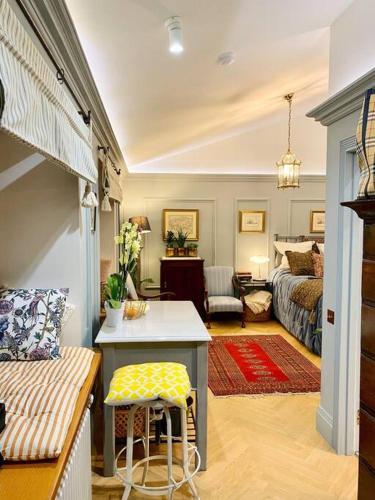 a living room with a bed and a living room with a table at Old Riga Designer Luxury Apartment in Riga