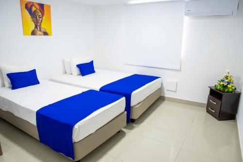Hotel ITACO tesisinde bir odada yatak veya yataklar