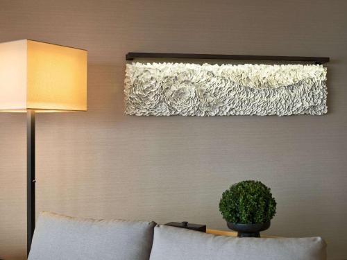 a living room with a couch and a potted plant at The Upper House in Hong Kong