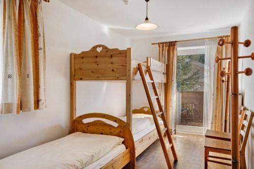 a room with two bunk beds and a window at Ferienwohnung Innerwalten 200 in San Leonardo in Passiria