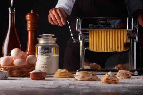 a person is making eggs in a kitchen with a mixer at Moon Palace Jamaica - All Inclusive in Ocho Rios