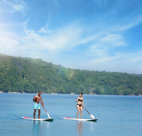 two people in the water on paddle boards in the water at Moon Palace Jamaica - All Inclusive in Ocho Rios