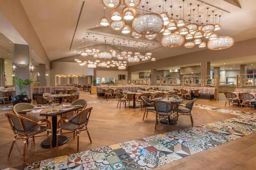 a restaurant with tables and chairs and chandeliers at Moon Palace Jamaica - All Inclusive in Ocho Rios
