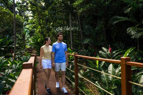 a man and a woman walking on a bridge in the jungle at Moon Palace Jamaica - All Inclusive in Ocho Rios
