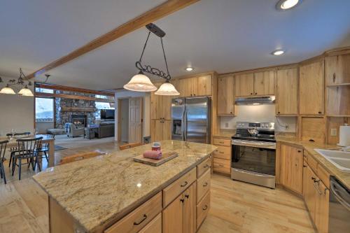 a large kitchen with wooden cabinets and a large island at Wild Huckleberry Alpine Cabin Fireplace and Deck! in Alpine